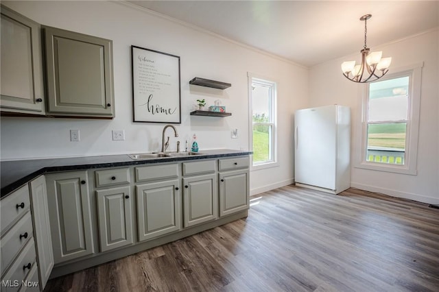 3153 SW Boltz Orchard Rd, Sugarcreek, OH 44681 - kitchen with freestanding refrigerator, a sink, ornamental molding, dark countertops, and wood finished floors