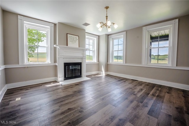 3153 SW Boltz Orchard Rd, Sugarcreek, OH 44681 - unfurnished living room with a chandelier, dark wood-style floors, a fireplace with flush hearth, and baseboards