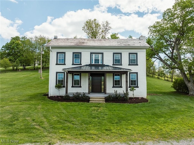 3153 SW Boltz Orchard Rd, Sugarcreek, OH 44681 - colonial home with covered porch, a standing seam roof, a front lawn, brick siding, and metal roof