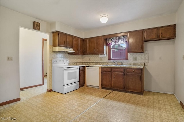 12395 Carter Rd, Concord, OH 44077 - kitchen featuring white appliances, under cabinet range hood, a sink, and light countertops