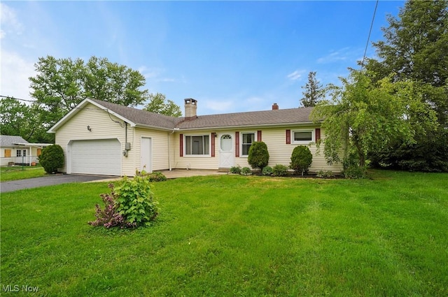 12395 Carter Rd, Concord, OH 44077 - ranch-style home featuring a garage, a chimney, asphalt driveway, and a front yard