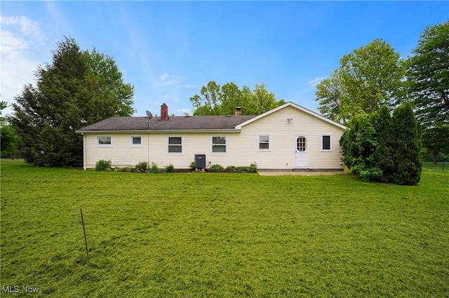 12395 Carter Rd, Concord, OH 44077 - back of house featuring a yard and a chimney