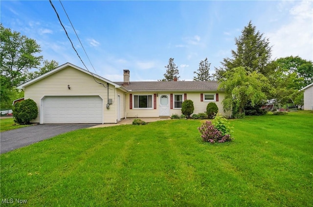 12395 Carter Rd, Concord, OH 44077 - ranch-style home featuring a garage, asphalt driveway, a front lawn, and a chimney