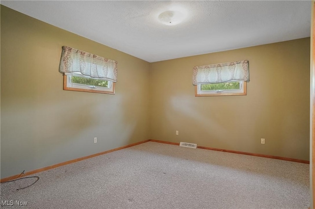 12395 Carter Rd, Concord, OH 44077 - carpeted spare room featuring baseboards and a textured ceiling