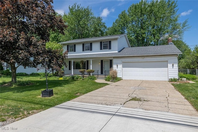 traditional-style home with covered porch, driveway, a garage, and a front lawn