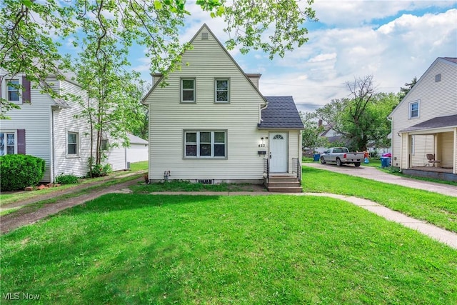 423 Kansas Ave, Lorain, OH 44052 - view of front of house featuring a front lawn, entry steps, and roof with shingles