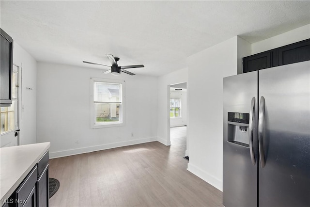 423 Kansas Ave, Lorain, OH 44052 - kitchen featuring stainless steel fridge, light wood-type flooring, ceiling fan, light countertops, and baseboards