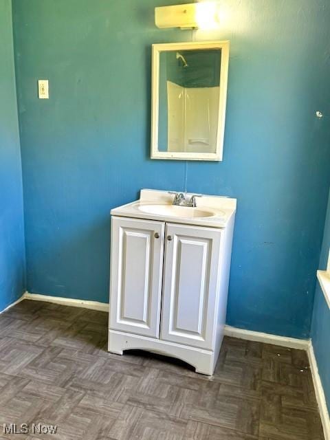 6815 Lawn Ave, Cleveland, OH 44102 - bathroom with baseboards, a shower, and vanity