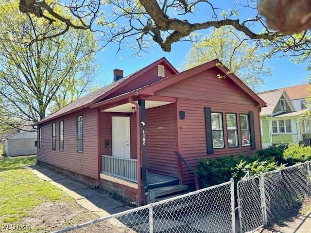 6815 Lawn Ave, Cleveland, OH 44102 - view of front of home with a fenced front yard and a chimney