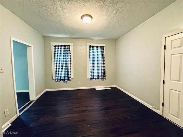 6815 Lawn Ave, Cleveland, OH 44102 - unfurnished room with wood finished floors, a textured ceiling, and baseboards