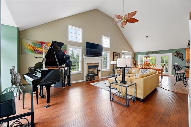 6868 Twin Oaks Ct, Canfield, OH 44406 - living area featuring high vaulted ceiling, ceiling fan, a glass covered fireplace, and wood finished floors