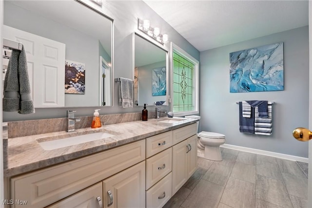 6868 Twin Oaks Ct, Canfield, OH 44406 - full bath with toilet, double vanity, and baseboards