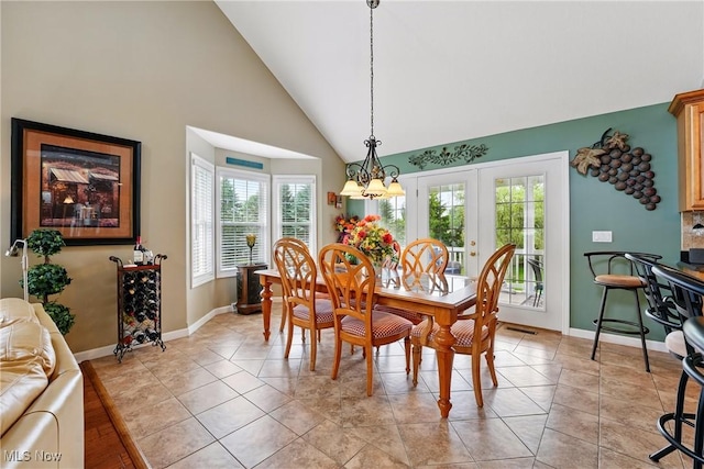 6868 Twin Oaks Ct, Canfield, OH 44406 - dining area with high vaulted ceiling, baseboards, a chandelier, french doors, and light tile patterned flooring