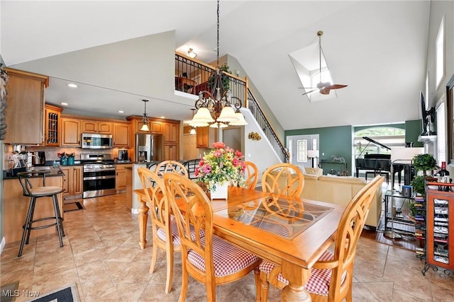 6868 Twin Oaks Ct, Canfield, OH 44406 - dining room with high vaulted ceiling, a ceiling fan, a chandelier, and recessed lighting