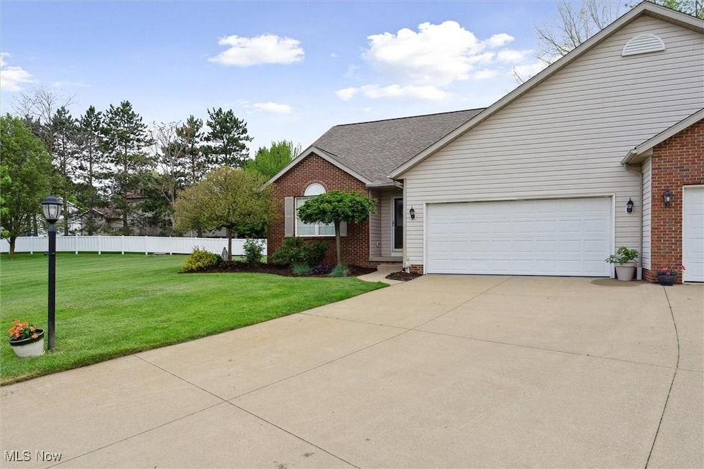 10382 Sudbury Cir NW, North Canton, OH 44720 - view of front of home with driveway, brick siding, an attached garage, and roof with shingles