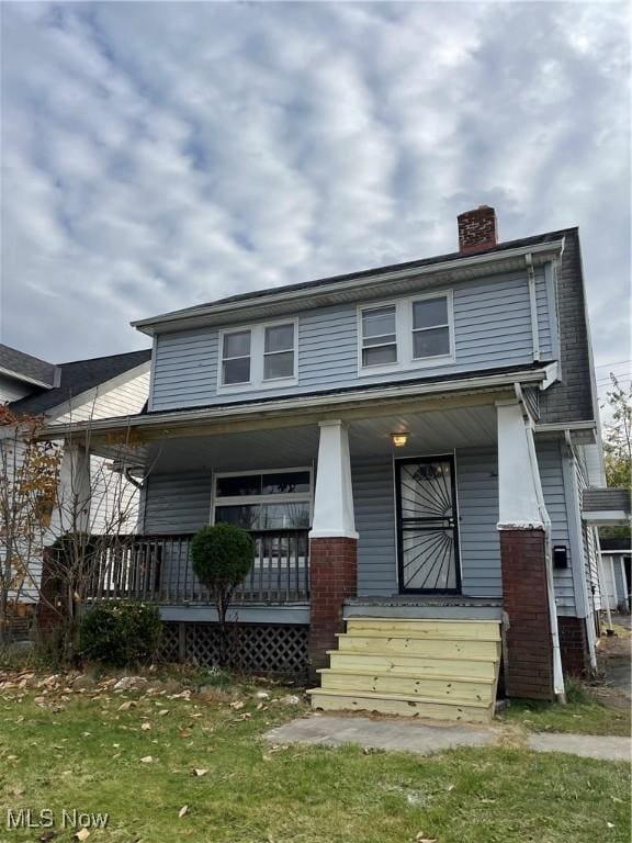 view of front of house featuring a porch and a chimney