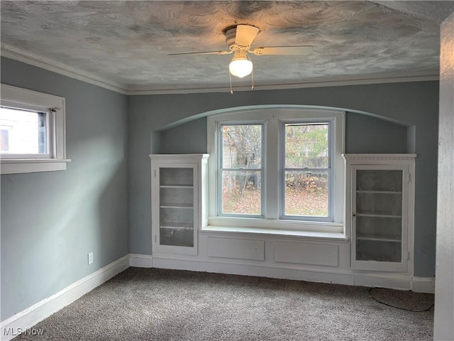 bonus room with carpet flooring, healthy amount of natural light, baseboards, and a ceiling fan