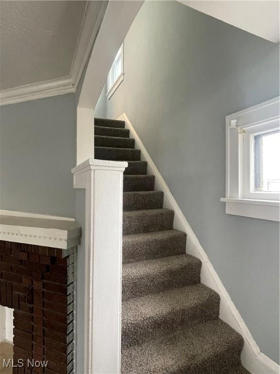 stairs featuring ornamental molding