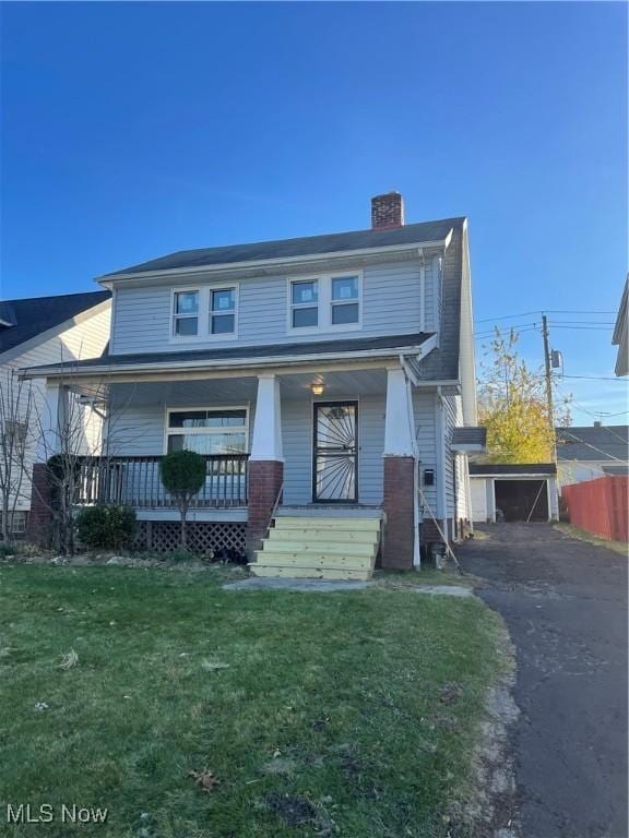 view of front of home featuring a chimney, driveway, and covered porch