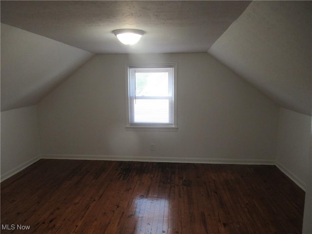 1397 Sunset Rd, Mayfield Heights, OH 44124 - bonus room with lofted ceiling, dark wood-style floors, and baseboards