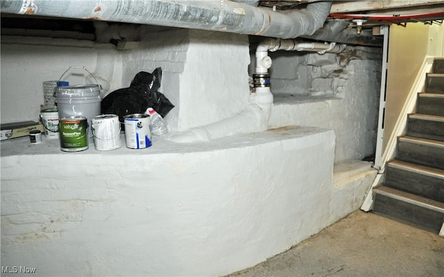 unfinished basement featuring stairs