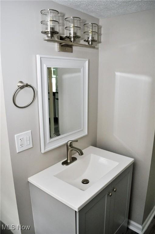 bathroom with a textured ceiling and vanity