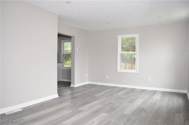 spare room featuring wood finished floors and baseboards