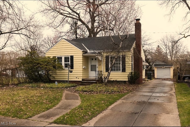 1115 Piermont Rd, South Euclid, OH 44121 - bungalow with an outdoor structure, concrete driveway, a chimney, a front yard, and a garage
