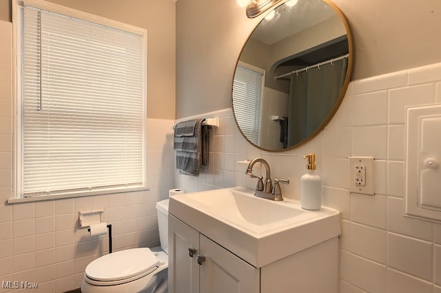1115 Piermont Rd, South Euclid, OH 44121 - bathroom with tile walls, toilet, vanity, and a wainscoted wall