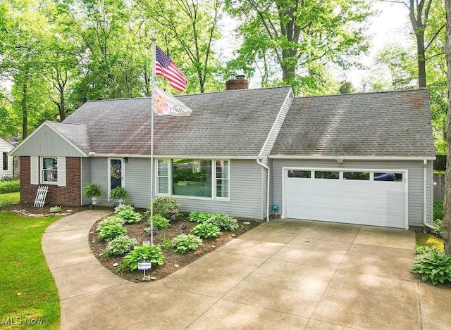 8159 Cherry Ln, Northfield Center, OH 44067 - view of front of property featuring an attached garage, a chimney, roof with shingles, and concrete driveway