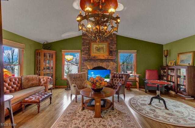 38 Choctaw Trl, Malvern, OH 44644 - sitting room with a chandelier, lofted ceiling, wood finished floors, and a fireplace