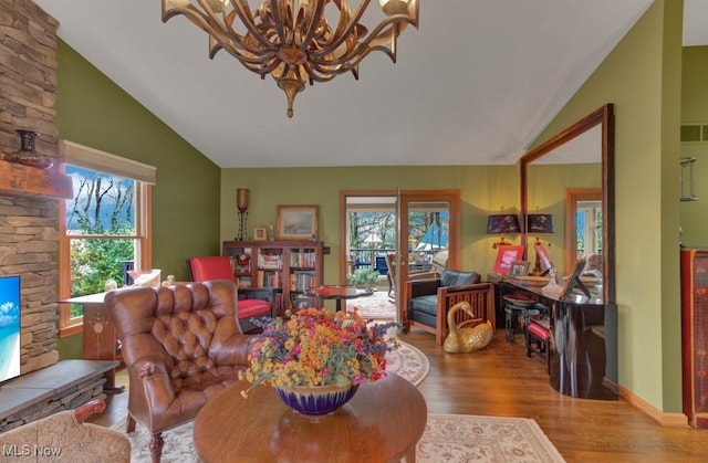 38 Choctaw Trl, Malvern, OH 44644 - living room with vaulted ceiling, wood finished floors, and a chandelier