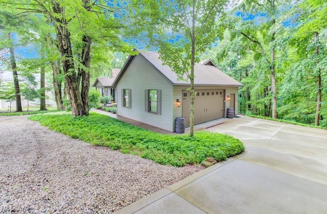 38 Choctaw Trl, Malvern, OH 44644 - view of property exterior featuring concrete driveway and an attached garage