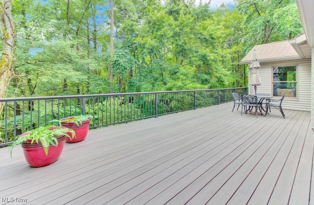 38 Choctaw Trl, Malvern, OH 44644 - wooden deck featuring outdoor dining area and a forest view