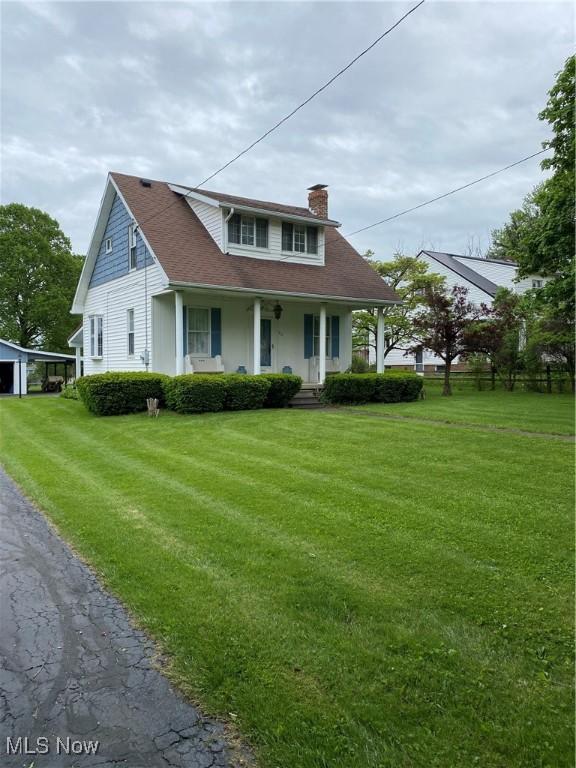 1912 Lisbon St, East Liverpool, OH 43920 - view of front of property with a chimney, covered porch, and a front yard
