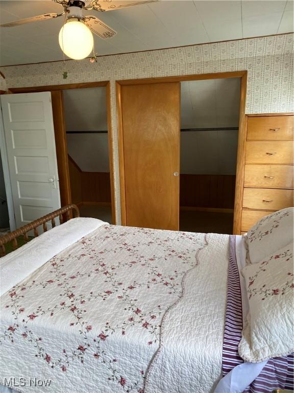 1912 Lisbon St, East Liverpool, OH 43920 - bedroom with wallpapered walls, two closets, and a ceiling fan