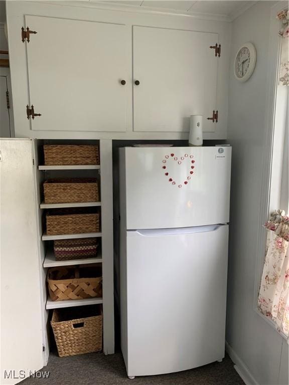 1912 Lisbon St, East Liverpool, OH 43920 - kitchen featuring freestanding refrigerator, carpet flooring, and white cabinetry