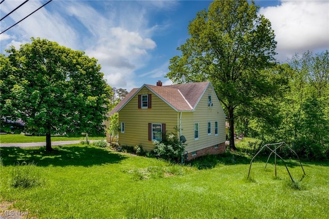 view of property exterior with a yard, a chimney, and roof with shingles