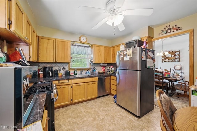 kitchen with appliances with stainless steel finishes, ceiling fan, a sink, tasteful backsplash, and dark countertops