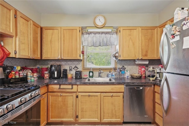 kitchen with stainless steel appliances, a sink, dark countertops, and tasteful backsplash
