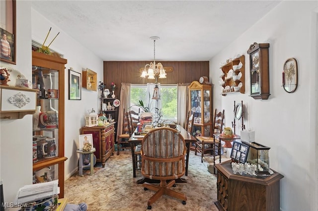 dining area with a chandelier and carpet