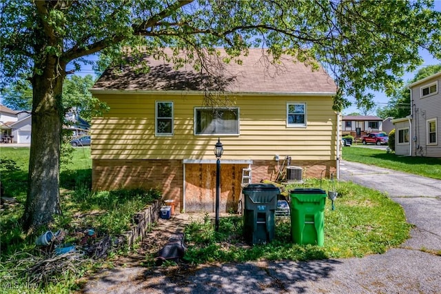 back of property featuring central AC unit