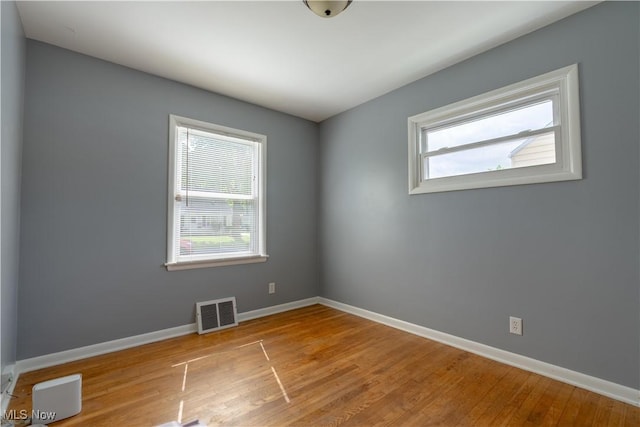 2930 Archwood Pl, Cuyahoga Falls, OH 44221 - empty room featuring healthy amount of natural light, baseboards, and wood finished floors