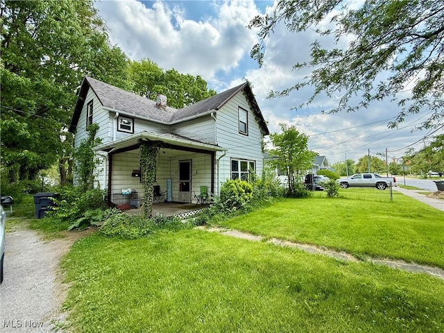 523 S Collett St, Lima, OH 45805 - view of front of house with a front lawn, a chimney, and a shingled roof