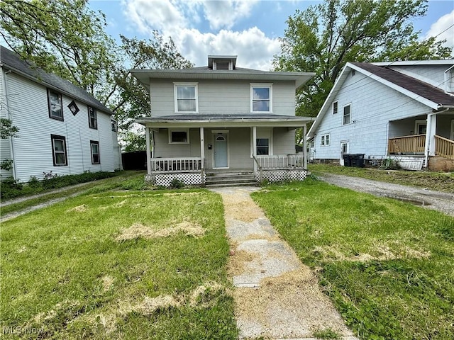 1017 Rice Ave, Lima, OH 45805 - american foursquare style home with covered porch, a front lawn, and central air condition unit