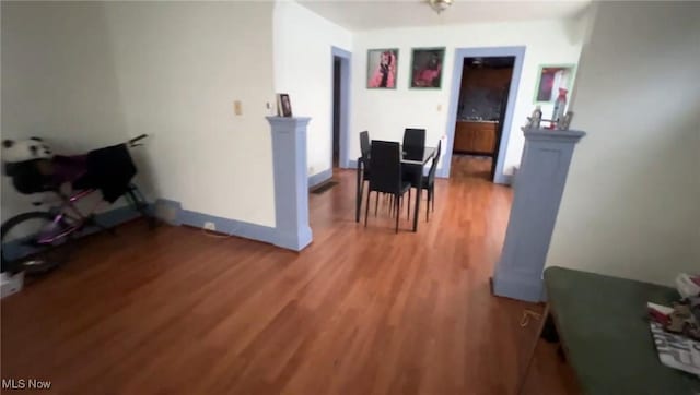 dining area with light wood finished floors and baseboards