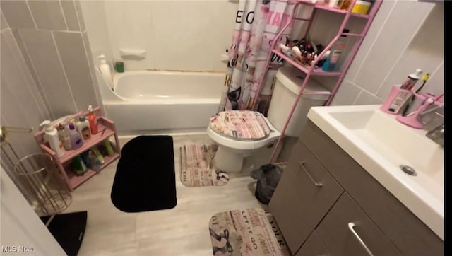 full bath featuring toilet, shower / tub combo, and vanity