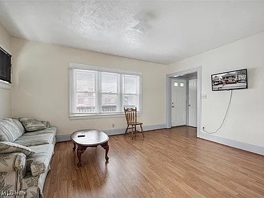 living area with wood finished floors and baseboards