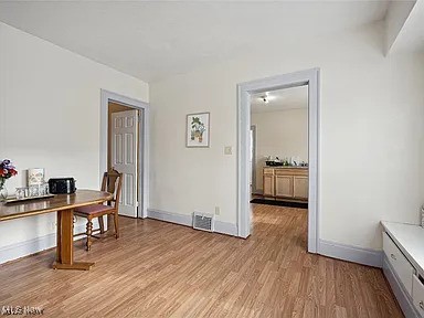 home office with light wood finished floors and baseboards