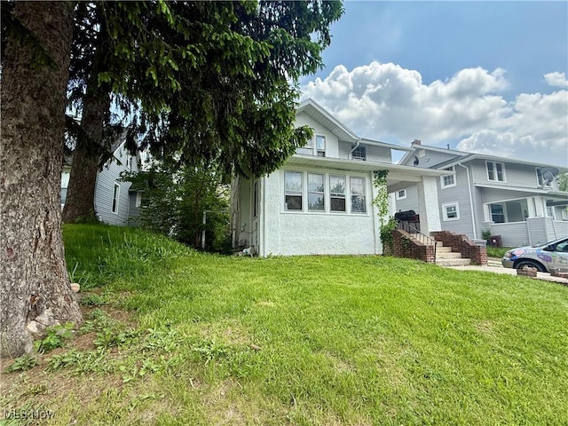327 Garfield Ave, Lima, OH 45805 - view of front of property with a front yard and stucco siding